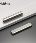 Two brushed nickel cabinet handles on a counter, part of a 10 Pack Adjustable Cabinet Handles In Brushed Nickel Square Satin Finish Drawer Pulls For Kitchen Cabinets Adjustable Hole Centers From 1 Inch To 4 Inches Center To Center From 25 Millimeters To 102 Millimeters Overall Length 4.41 Inches set.