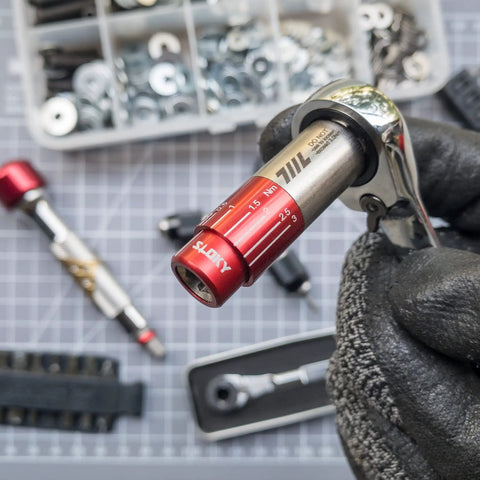 Hand holding Pocket Size Precision Torque Driver With Mini Indexed Wrench And Variable Torque Control Works With Quarter Inch And Twelve Millimeter Sockets close-up