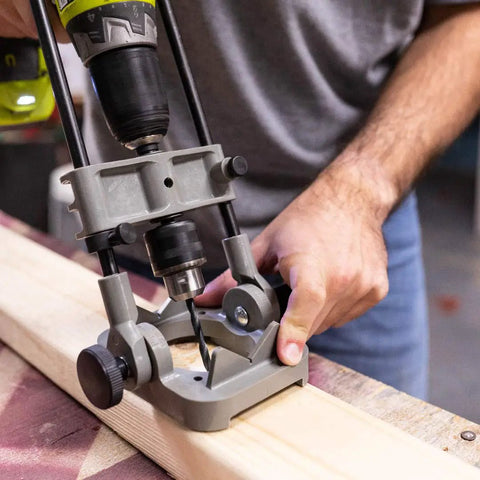 Man using DIY Friendly Portable Precision Drill Guide For 3/8 And 1/2 Inch Drills With Built In Protractor on wooden board