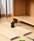 4 Piece Adjustable Furniture Leveling Feet With 3/8-16 Inch Thread, Rugged Heavy Duty Carbon Steel Table Leg Levelers With Plastic Base, Floor Protection For Chairs Tables Cabinets, Keeps Your Setup Level On Any Surface. Adjustable black furniture leveling foot on wooden cabinet base, threaded carbon steel, plastic pad