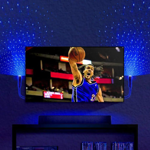 Starport USB Laser Star Projector For Game Rooms And Bedrooms, Portable Galaxy Mood Lighting illuminates wall with blue stars.