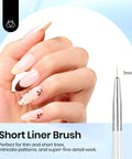Hand holding nails painted with floral detail next to 7mm brush tip from 5 Pcs Nail Art Liner Brush Set With Metal Handles For Long Lines And Fine Details In 7mm 11mm 15mm 20mm And 25mm Sizes Perfect For Dotting, Painting, Gel Nail Art, Detailing, And DIY Mani Gift For Women.