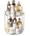 Two Tier Clear Rotating Vanity Organizer With Smooth 360 Degree Spin For Skincare And Perfume Beauty Essentials Storage displayed with various beauty products.