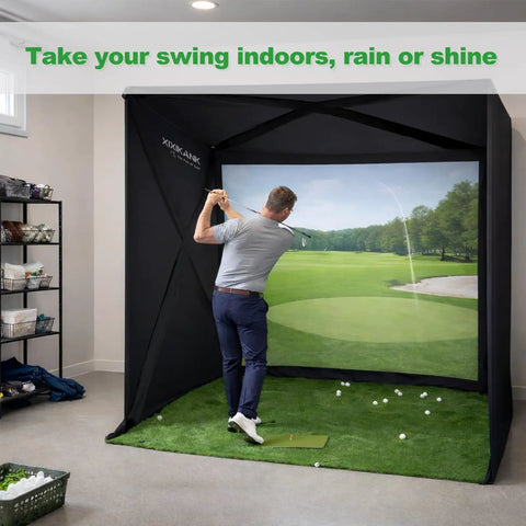 Man practicing golf indoors with Home Golf Simulator Enclosure Complete Set With Heavy Duty Frame And HD Impact Screen And Pro Grade Putting Green Turf 8x8 Ft Tool Free Quick Setup In Under 5 Minutes Hitting Cage For Indoor Practice.