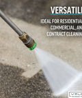 Close-up of a pressure washer nozzle tip with a green ring on a metal wand spraying water on concrete.