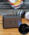Close-up of Aroma Mini 5W Guitar Amp with earphone connection, showcasing clean and overdrive channels and control knobs.