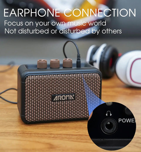 Close-up of Aroma Mini 5W Guitar Amp with earphone connection, showcasing clean and overdrive channels and control knobs.