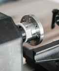 Close-up of Heavy Duty 1x8Tpi Face Plate Kit For Woodturning Lathes, featuring steel plate and nylon washer on lathe.