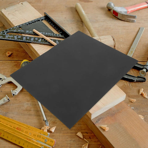 Fine Grit Sandpaper Sheets For Woodworking And Crafts With Smooth Finish on a wooden workbench surrounded by tools.