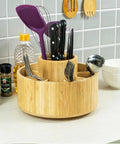 Large Bamboo 360 Degree Rotating Pencil Holder Desk Organizer with 11 compartments holding kitchen tools on countertop