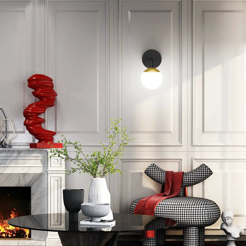 Black and Gold Globe Wall Sconce Mid Century Modern One Light Fixture in stylish living room with decorative elements.