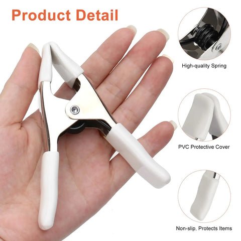 Beastly Grip Heavy Duty 4 Inch Spring Clamps For Backdrops with white protective cover shown over hand.