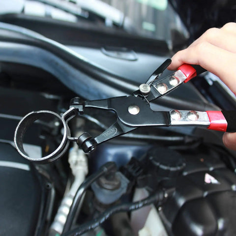 Close-up of 9 Piece Hose Clamp Pliers Set with Long Reach Clic R Swivel Jaw in use on car engine hose.