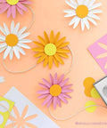 Colorful paper flowers made using Circle Punch 1.75 Inch with Safety Lock for card making and scrapbooking on an orange background