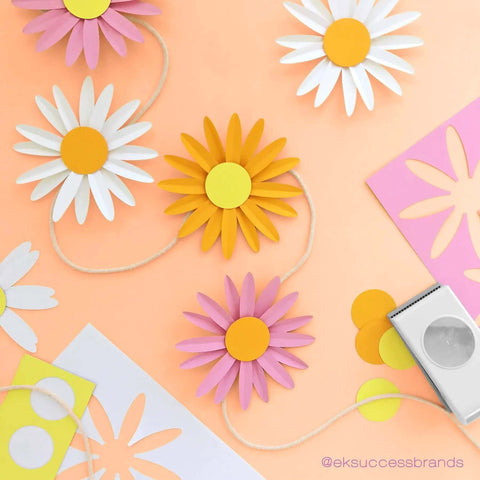 Colorful paper flowers made using Circle Punch 1.75 Inch with Safety Lock for card making and scrapbooking on an orange background