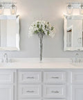 Octave Bohemian Clear Glass Bathroom Vanity Wall Light Two-Light Fixture With Boho Chic Vibe above a double sink vanity