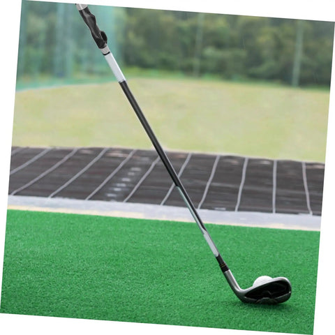 Golf Grip Trainer Pro Grade Swing Training Device on a golf mat at the range showing alignment for improved aim and precise swings.