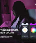 Person using Candelabra LED Bulbs RGB Color Changing Smart Bulbs E12, 6W with app control on smartphone screen in dim room.
