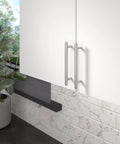 Roosevelt Collection Brushed Nickel Cabinet Handle Five And One Sixteenth Inch Center To Center Bar Pull on a white cabinet