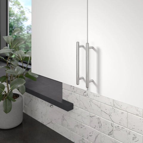 Roosevelt Collection Brushed Nickel Cabinet Handle Five And One Sixteenth Inch Center To Center Bar Pull on a white cabinet