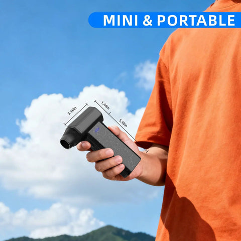 Person holding Cordless Air Duster 150000 RPM Turbo Power Mini Handheld Blower for cleaning, with hills in background.