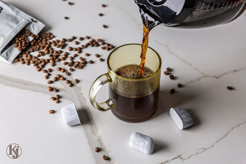 Pouring coffee with 12 Pack Charcoal Coffee Filter Replacements For Cuisinart And Braun BrewSense Coffee Makers beside cup