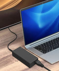 12V 5A Power Supply Adapter 60W With 100 240V AC Input To DC 12V Output For LED Strips CCTV Cameras Routers TV Boxes Webcams Speakers And More No Fuss Plug And Play Safe Stable black adapter connected to laptop-style device