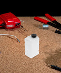 Workshop table with Clear 120CC RC Plane Fuel Tank Set With Metal Tubing And Engine Container in center.