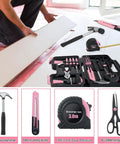58 Piece Household Tool Set With Pink Plastic Toolbox Case For Everyday Home Repairs And DIY Projects, Includes Hammer, Pliers, Screwdrivers, Tape Measure, And More, All Purpose Tools, Ideal Starter Kit For Women And Beginners displayed with man measuring wood board