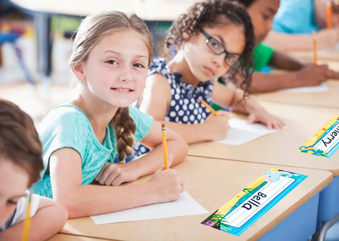 Children in classroom using 36 Sea Animals Desk Name Plates For Classroom Kid Friendly Personalized Name Tags For Kids And Students Adhesive Labels For Desks Chairs And Lockers Back To School Decor on desks.