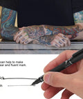 Hella Smooth Dual Tip Marking Kit Bold And Ultra Fine Felt Scribes For Piercing Positioning Aesthetic Procedures And Surgical Stenciling Top Shelf Removable Studio Grade Tools 10 Piece Set Black in use on clear paper.