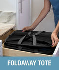 Person placing collapsible laundry caddy 2 pack 64L cream charcoal foldable laundry basket in drawer for storage.
