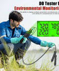 Man using All In One Water Quality Meter For Aquariums And Hydroponics With Dissolved Oxygen pH Salinity TDS EC And Temp Bluetooth Data Logging And Calibration Kit For Fish Tanks Ponds Brewing by a lake with digital display