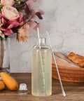 Long Handle Stainless Steel Stirring Spoon 10 Inch Durable Home Bar Tool beside bottle on wooden table