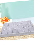 Lowkey Perfect Multi Grid Jewelry Tray For Rings And Necklaces With Smart Dividers on a woven surface with compartments for sorting.