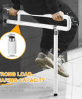 Person demonstrating strength of Foldable Toilet Grab Bar 29.5 Inch with Flip Up Design Safe Handicap Rail for Bathroom Anti Slip Leg Support