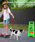 Green Kids At Play Safety Sign 24 inches next to child with skateboard and dog, featuring reflective tapes, urging caution for drivers.