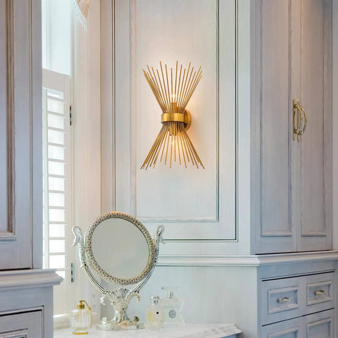 Gold Starburst Wall Sconce Vanity Light With Two Bulbs For Bathroom Hallway And Bedroom Mid Century Modern Indoor Lighting Vintage Style Wall Lamp Dope Vibe Home Decor 11 By 4.7 By 15.8 Inches mounted on wall in elegant bathroom setting.