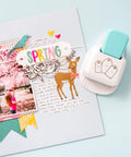 3-In-1 Round Tag Punch for Crafting and Scrapbooking beside a spring-themed scrapbook page