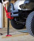 Beefy 48 Inch Ratcheting Off Road Utility Farm Jack, 3 Ton Capacity, lifting vehicle in auto shop, red finish