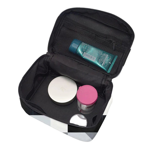 Your Holy Grail Travel Makeup Bag Features A Cool Black And White Piano Grid Design With Seriously Huge Storage Internal Mesh Pockets And Stretchy Rings To Keep Your Vanity Stuff Sorted For Gym Rats Or Campers, open showing organized skincare products.