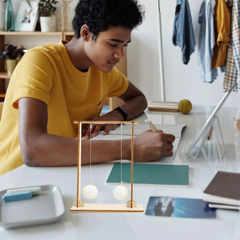 Student using Two-Piece Physics Experiment Kit For Students, Engaging Science Tools For Classroom And Home Learning on desk.