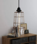 Sharp Bronze Metal Wire Cage Guard For Pendant Lamps With Badass Build Quality And Fly Design No Sweat Setup For Creative Lighting Projects And Chic Ceiling Lamp Shields hanging pendant lamp with clear bulb and bronze wire cage over wooden table.