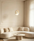 HLRCB Indoor Pendant Light, Cream White, Globe Shade Suspended Mount above a modern beige sofa in a stylish living room.