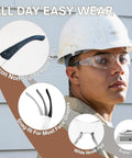 Worker wearing 120-pack clear safety glasses with ANSI Z87.1 rating, featuring silicone tips and wraparound design for comfort and protection.