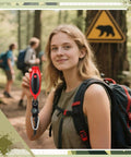 Hiker holding red 125 dB Bear Horn with Compass and Thermometer for hiking and camping in bear warning area