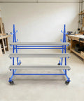 Heavy Duty Horizontal Storage Rack With Smooth Rolling Wheels And Built Tough Double Sided Frame For Long Pipes And Steel Bars Holding Up To Five Hundred Pounds in a workshop.