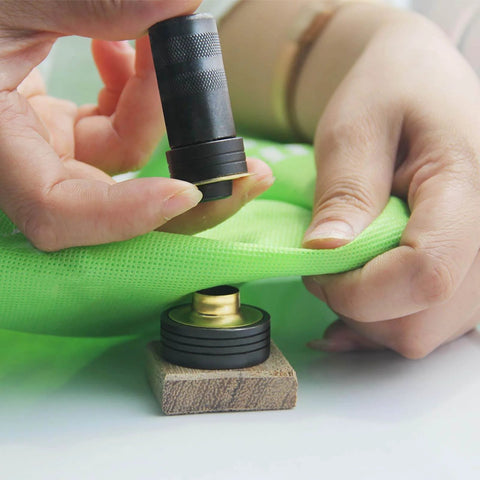 Using Solid Brass Grommet Kit With Three Eighths And One Half Inch Grommets Eyelets Setting Tool And Storage Box NH1003K on green fabric
