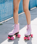 Person wearing pink roller skates outdoors
