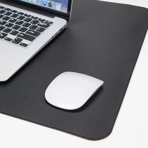Large Desk Pad 47.2 Inch By 17 Inch Leather Desk Pad Protector With Natural Cork And PU Leather Grippy Non Slip Waterproof Office Mat with a laptop and mouse.